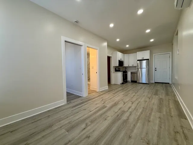 a view of a kitchen with a sink and a refrigerator