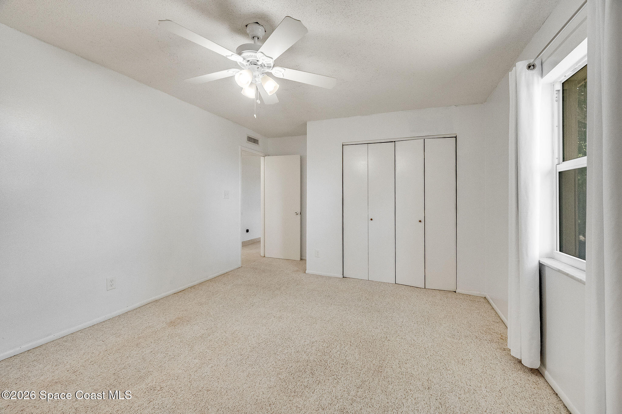 4304 London Town Road, Unit D224 Titusville, FL 32796 - Photo 14 of 32 an empty room with chandelier fan