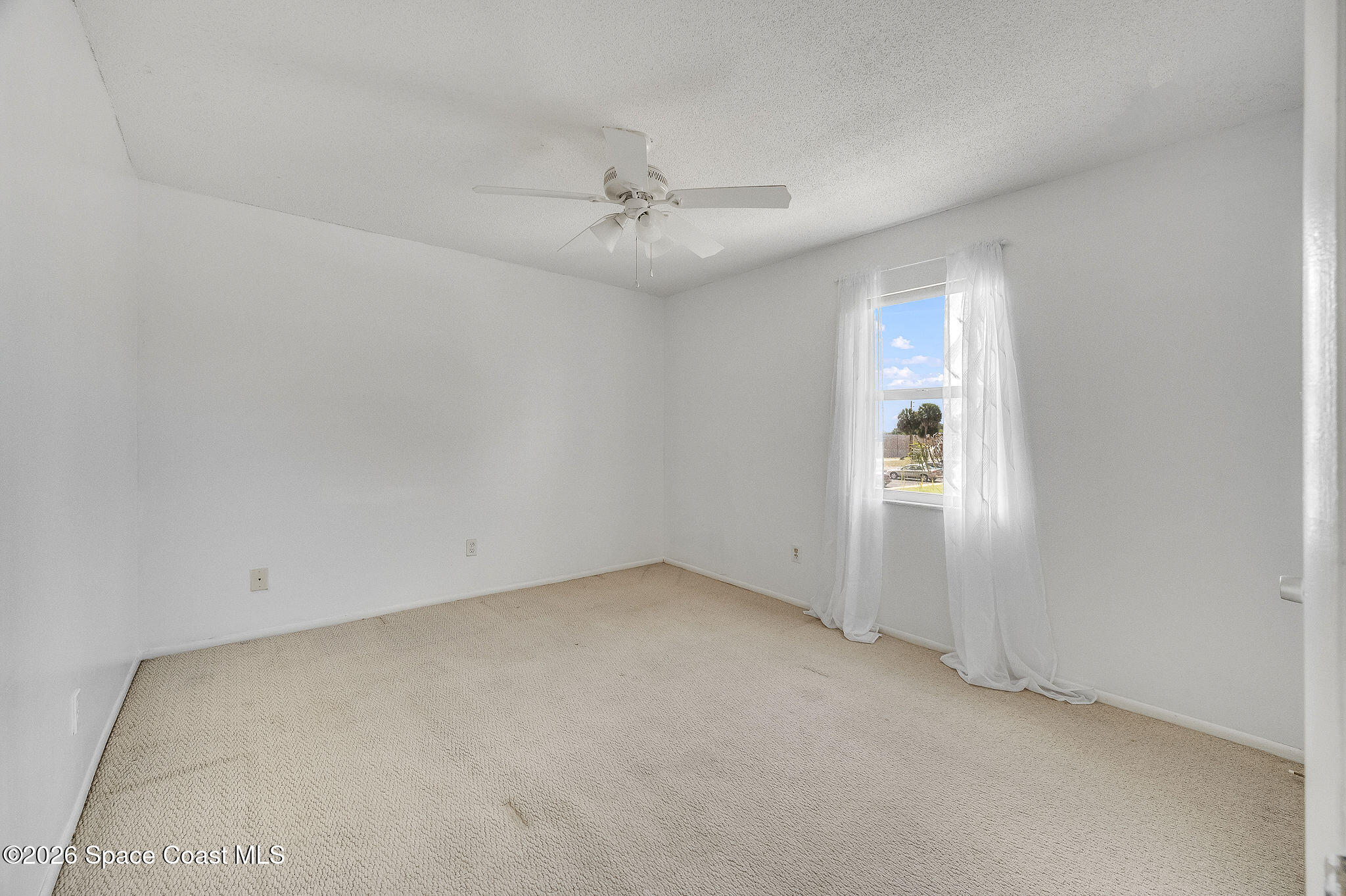 4304 London Town Road, Unit D224 Titusville, FL 32796 - Photo 15 of 32 an empty room with a window and ceiling fan