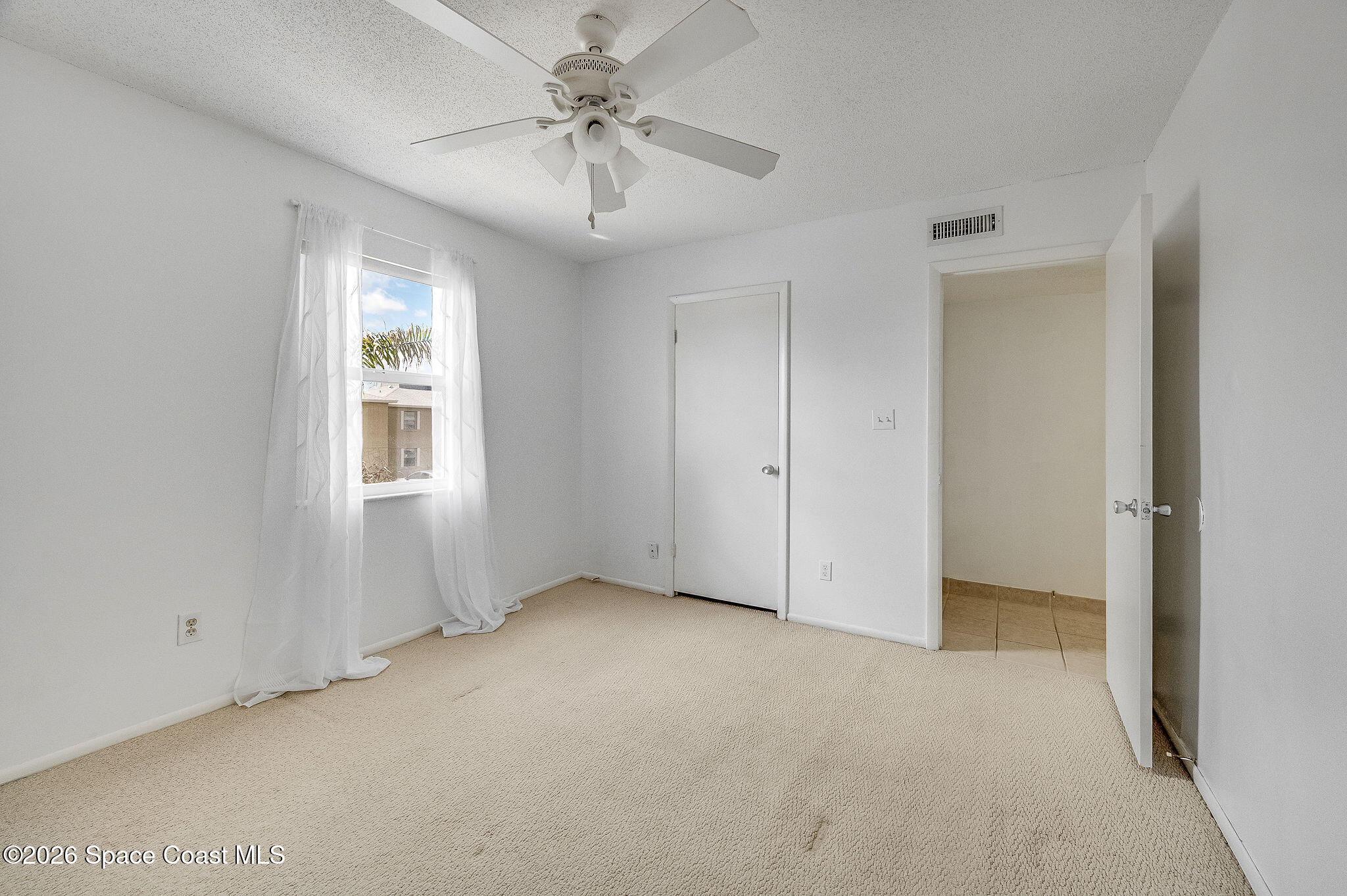 4304 London Town Road, Unit D224 Titusville, FL 32796 - Photo 16 of 32 a view of an empty room with a window