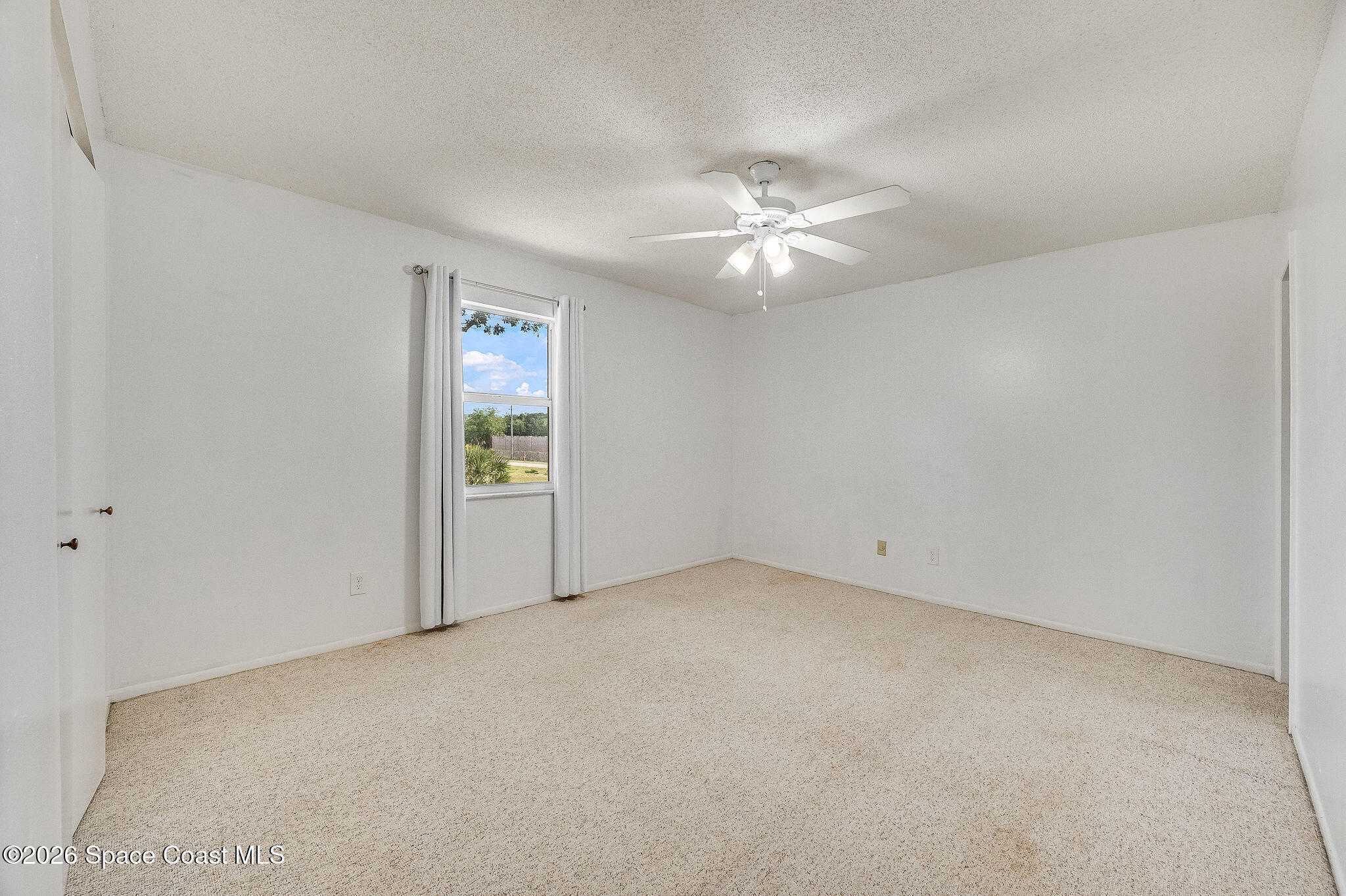 4304 London Town Road, Unit D224 Titusville, FL 32796 - Photo 17 of 32 an empty room with a window and ceiling fan