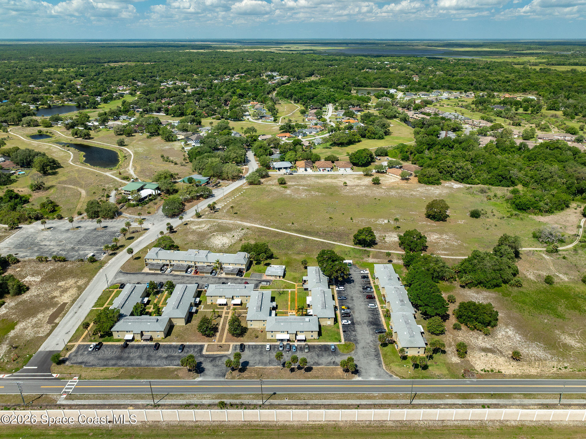 4304 London Town Road, Unit D224 Titusville, FL 32796 - Photo 31 of 32 an aerial view of residential houses with outdoor space and trees