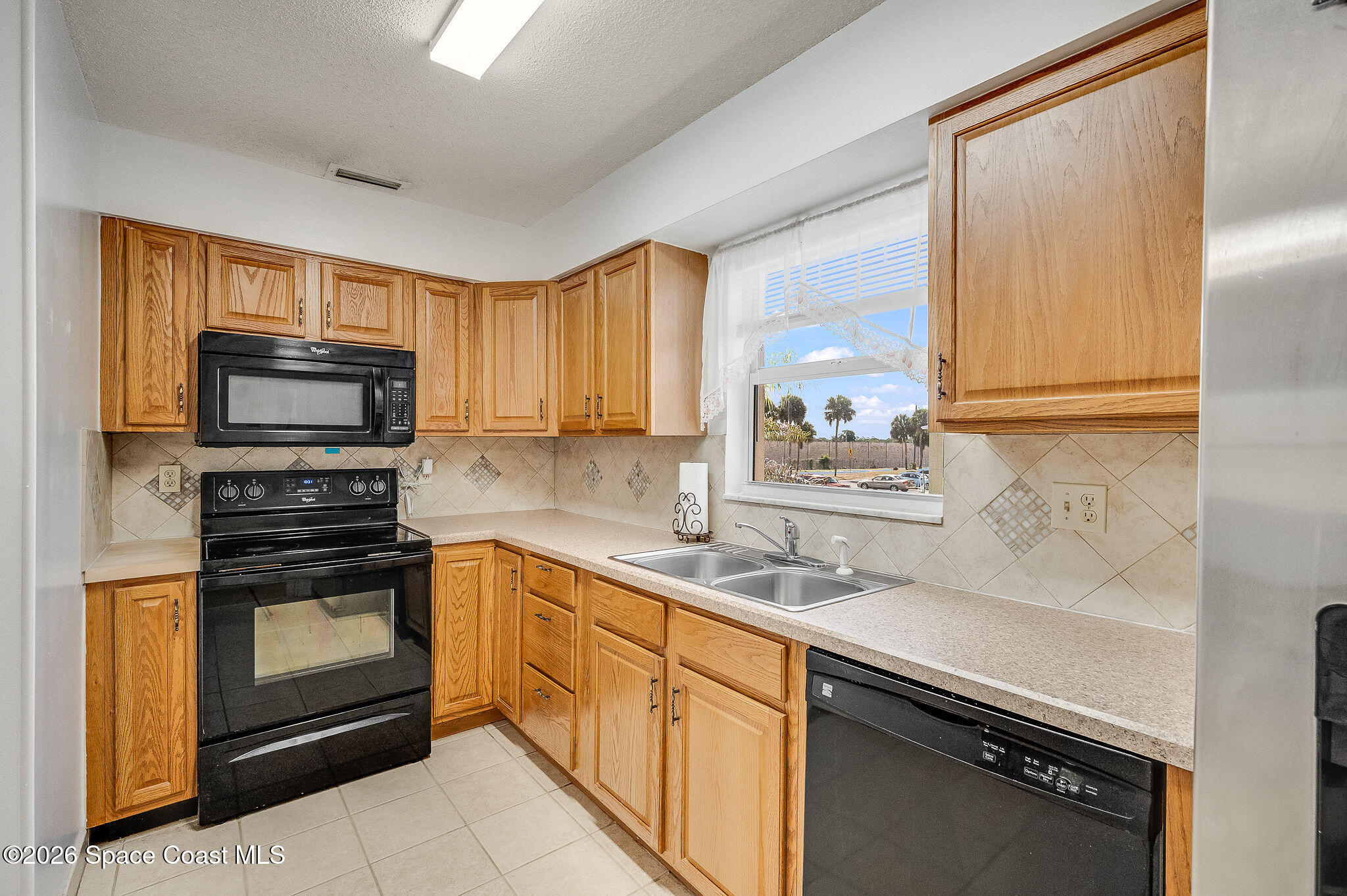 4304 London Town Road, Unit D224 Titusville, FL 32796 - Photo 7 of 32 a kitchen with a sink stove and microwave