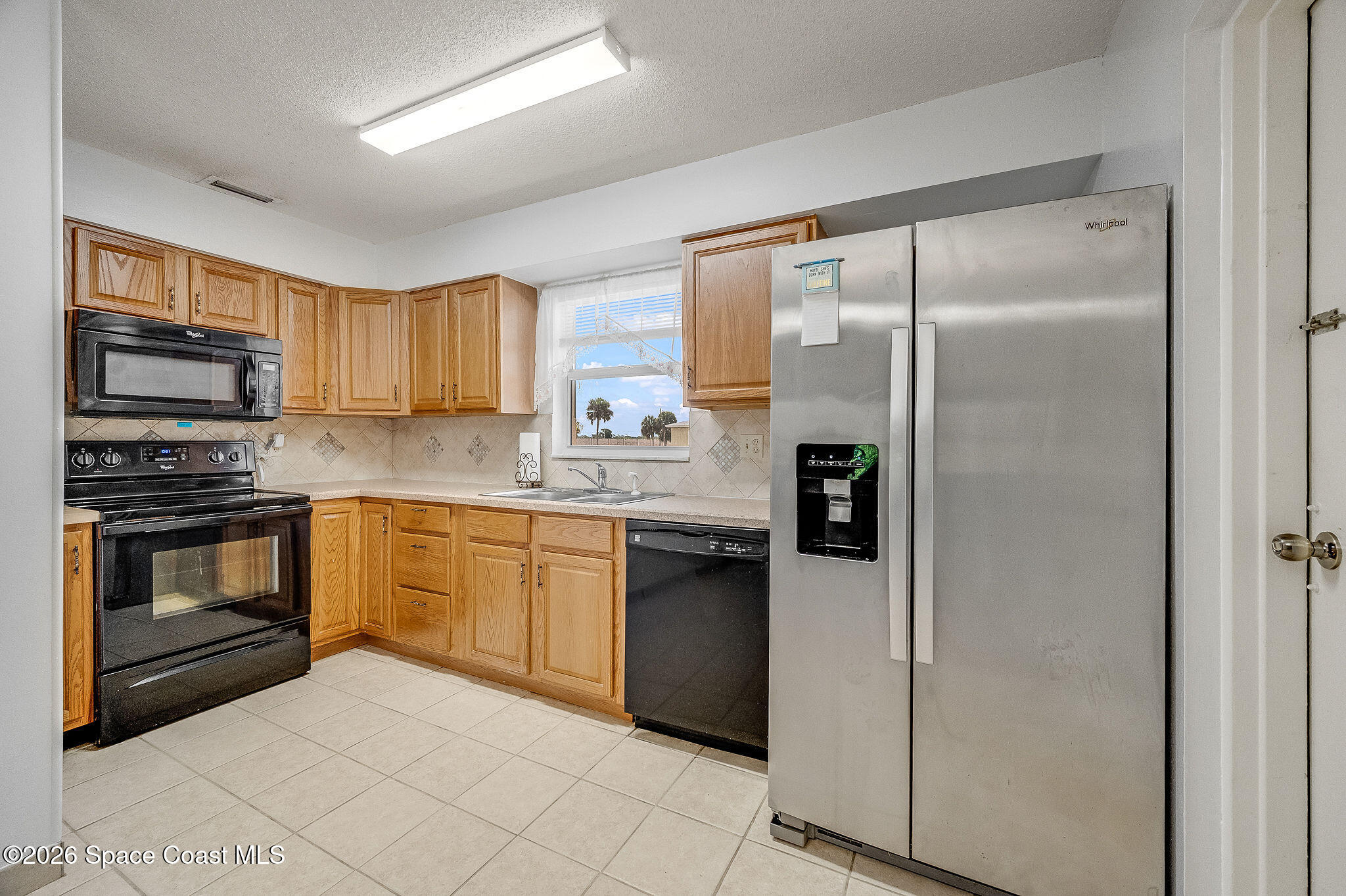 4304 London Town Road, Unit D224 Titusville, FL 32796 - Photo 8 of 32 a kitchen with stainless steel appliances granite countertop a refrigerator stove and sink