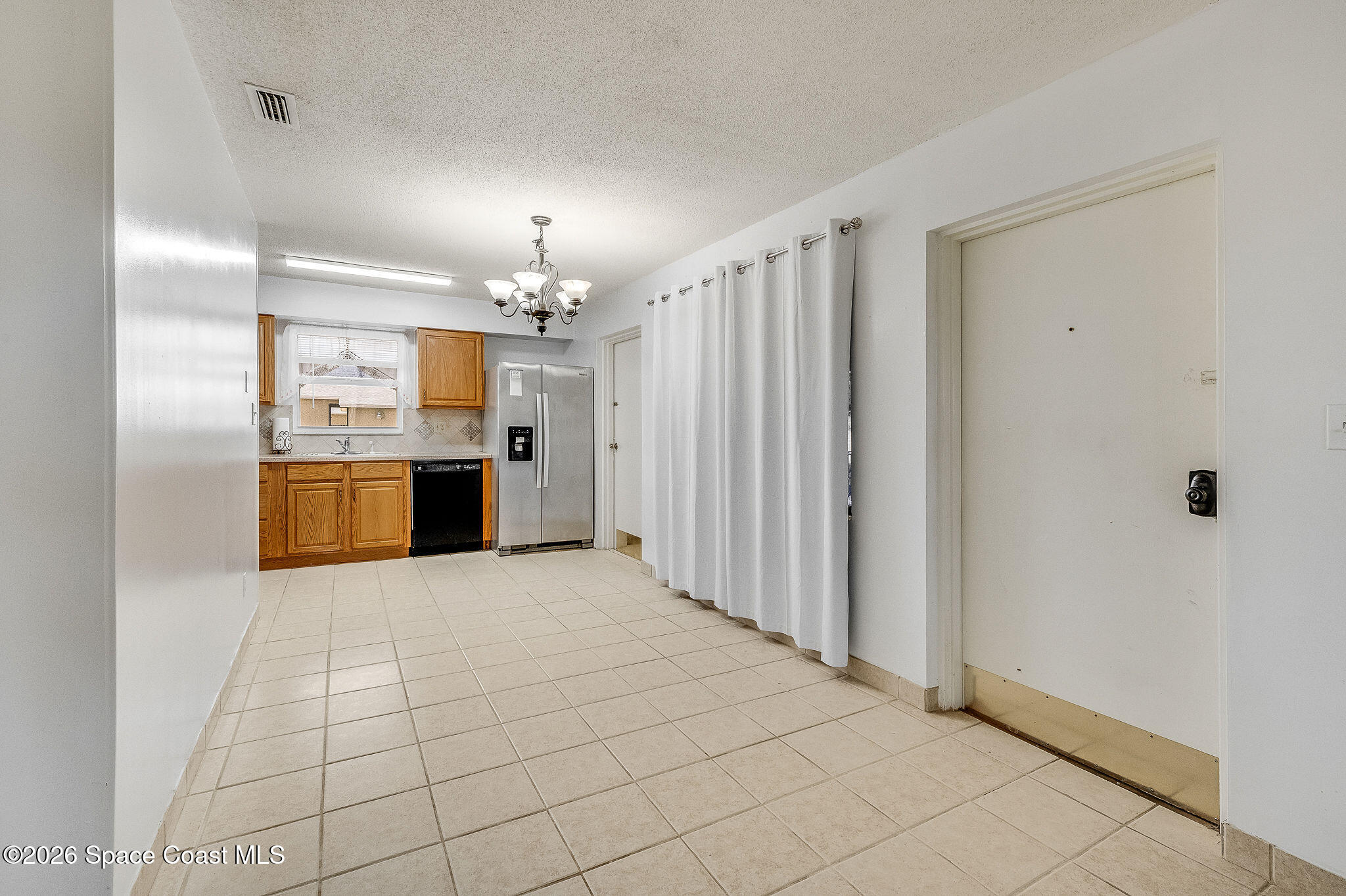4304 London Town Road, Unit D224 Titusville, FL 32796 - Photo 9 of 32 a large kitchen with cabinets and stainless steel appliances