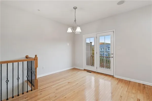 a view of a livingroom with wooden floor and staircase