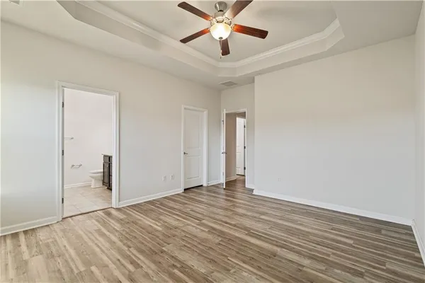 a bathroom with a granite countertop sink a toilet and a mirror