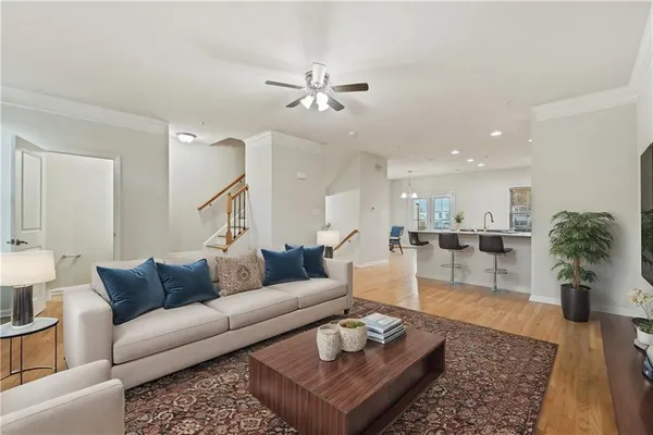 a living room with furniture and wooden floor