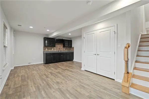 a kitchen with granite countertop a sink and cabinets