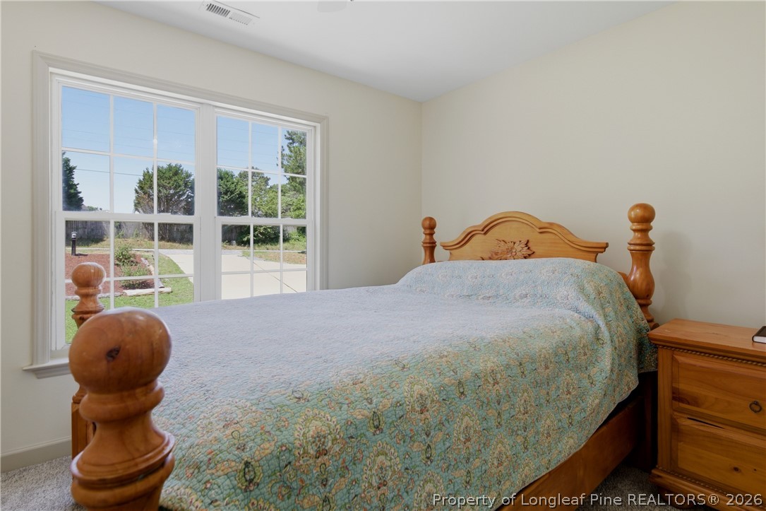 1075 Buffalo Lake Road Sanford, NC 27332 - Photo 32 of 49 a bed sitting in a room next to a window
