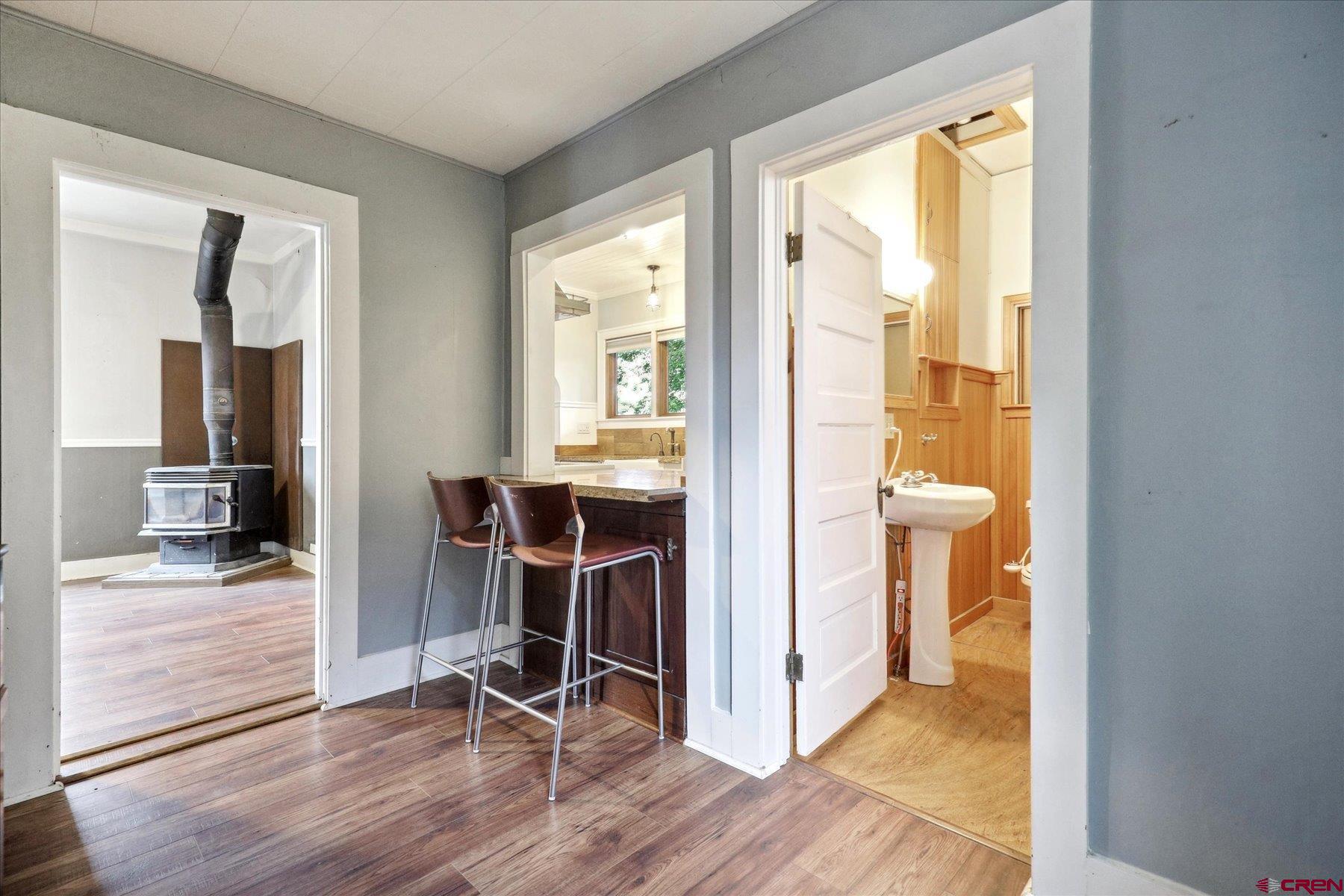 438 Bauer Avenue Mancos, CO 81328 - Photo 13 of 30 a view of a hallway with wooden floor and a bathroom
