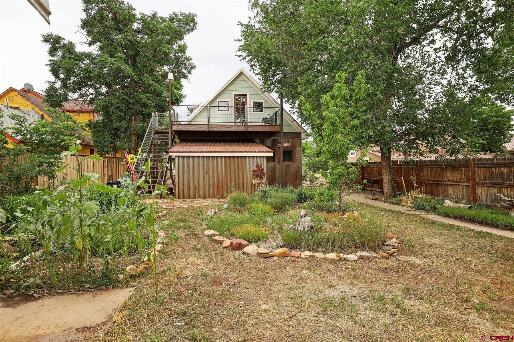 438 Bauer Avenue Mancos, CO 81328 - Photo 18 of 30 a front view of a house with a yard and tree s