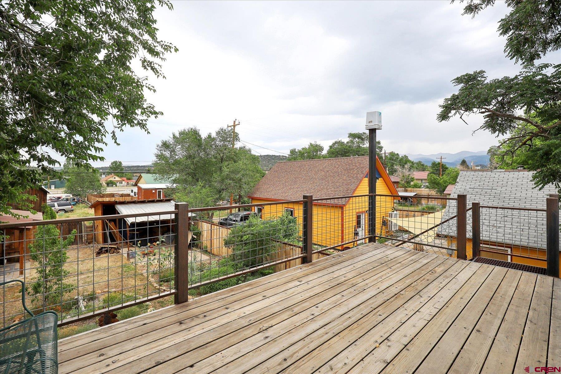 438 Bauer Avenue Mancos, CO 81328 - Photo 19 of 30 a view of a balcony with wooden floor and iron fence