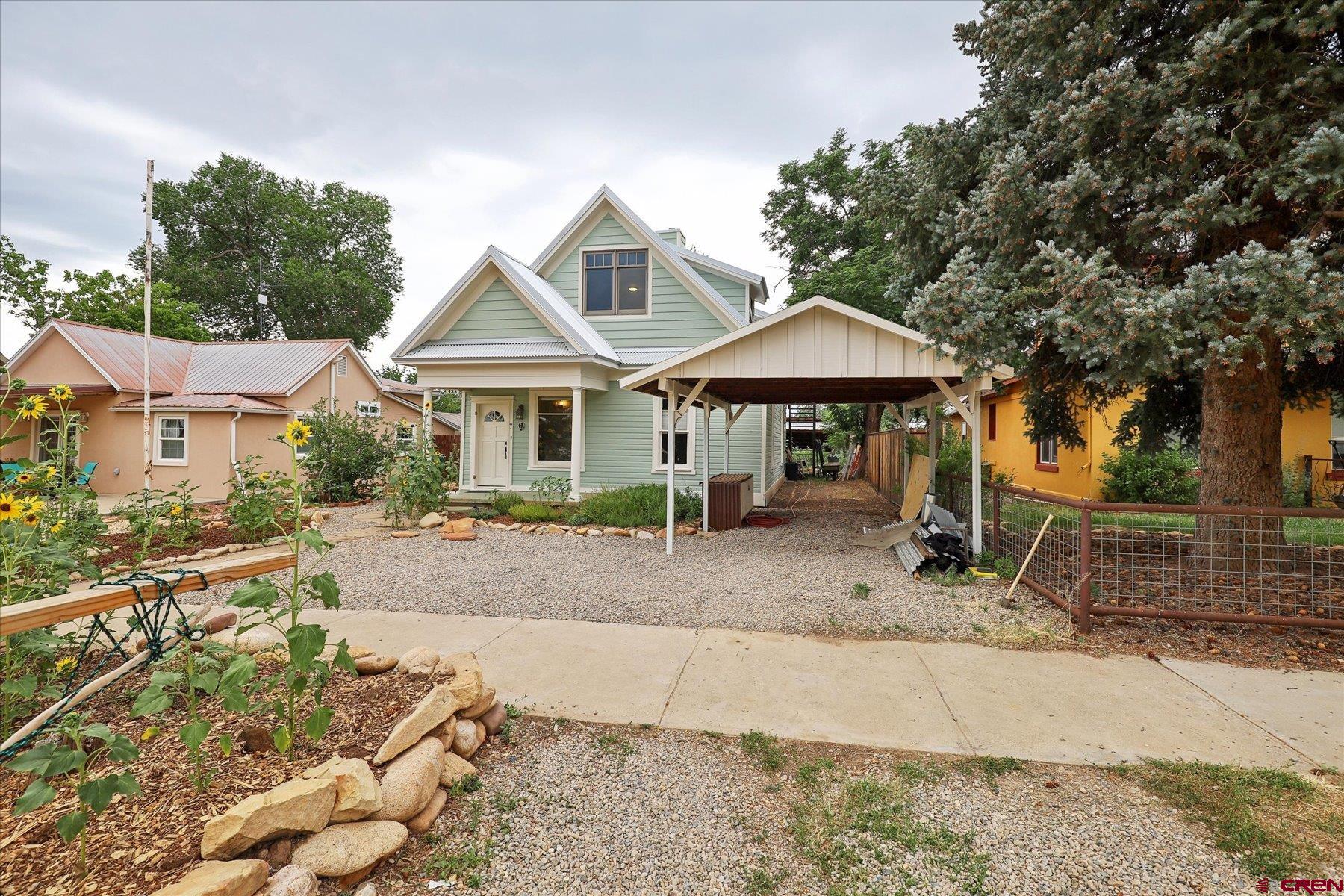 438 Bauer Avenue Mancos, CO 81328 - Photo 2 of 30 a patio with a table and chairs under an umbrella
