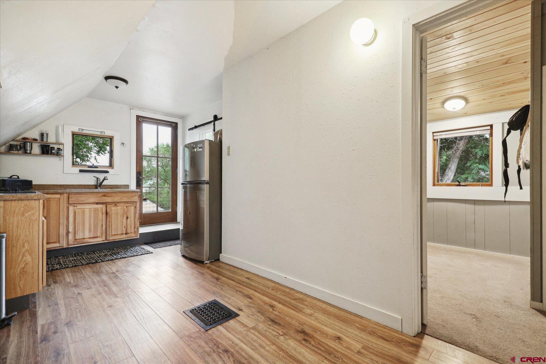 438 Bauer Avenue Mancos, CO 81328 - Photo 25 of 30 a kitchen with stainless steel appliances wooden floor and window