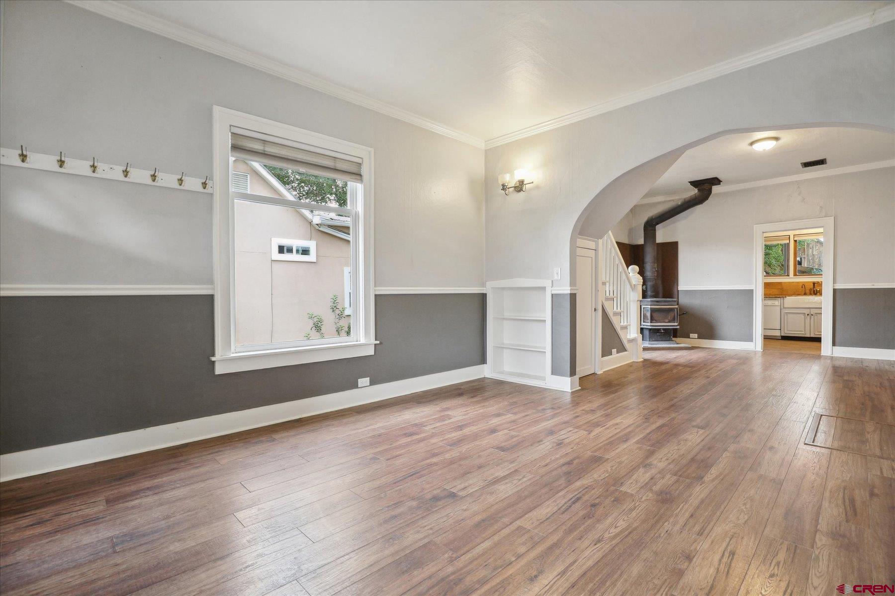 438 Bauer Avenue Mancos, CO 81328 - Photo 4 of 30 an empty room with wooden floor and windows