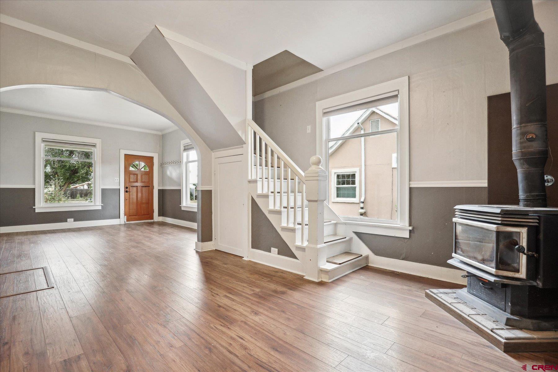 438 Bauer Avenue Mancos, CO 81328 - Photo 5 of 30 a view of empty room with wooden floor and fireplace
