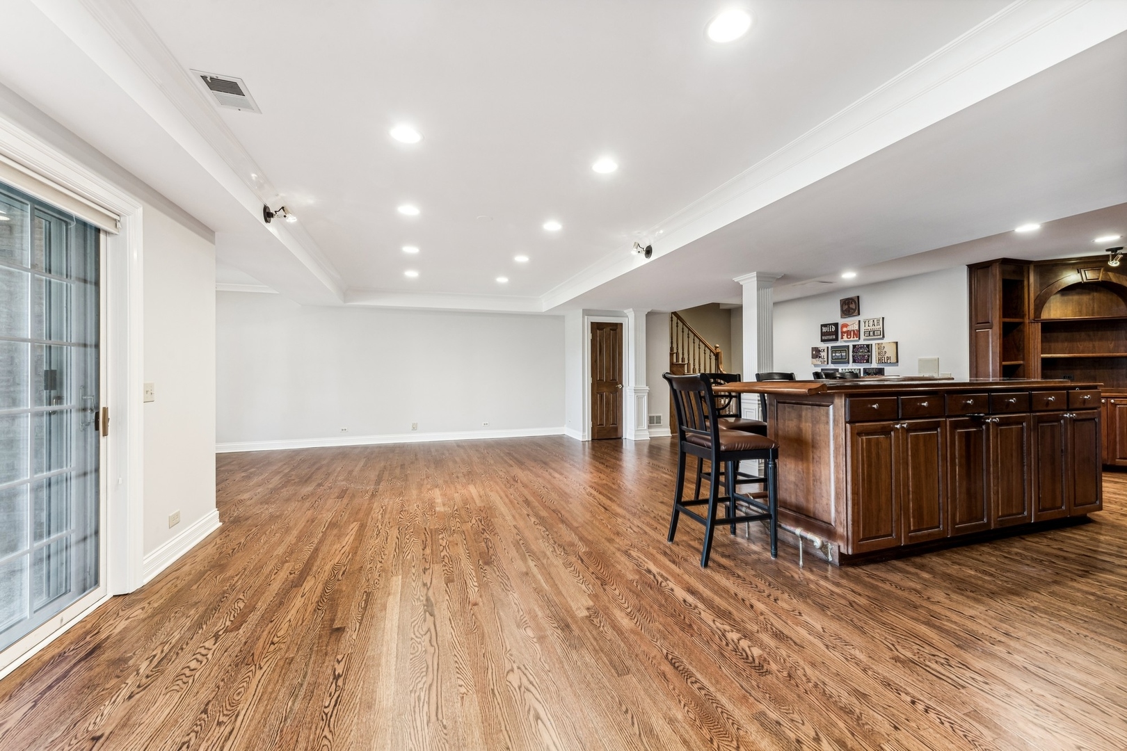 1334 Brandywine Road Libertyville, IL 60048 - Photo 21 of 32 a kitchen with stainless steel appliances kitchen island granite countertop wooden floors and wooden cabinets