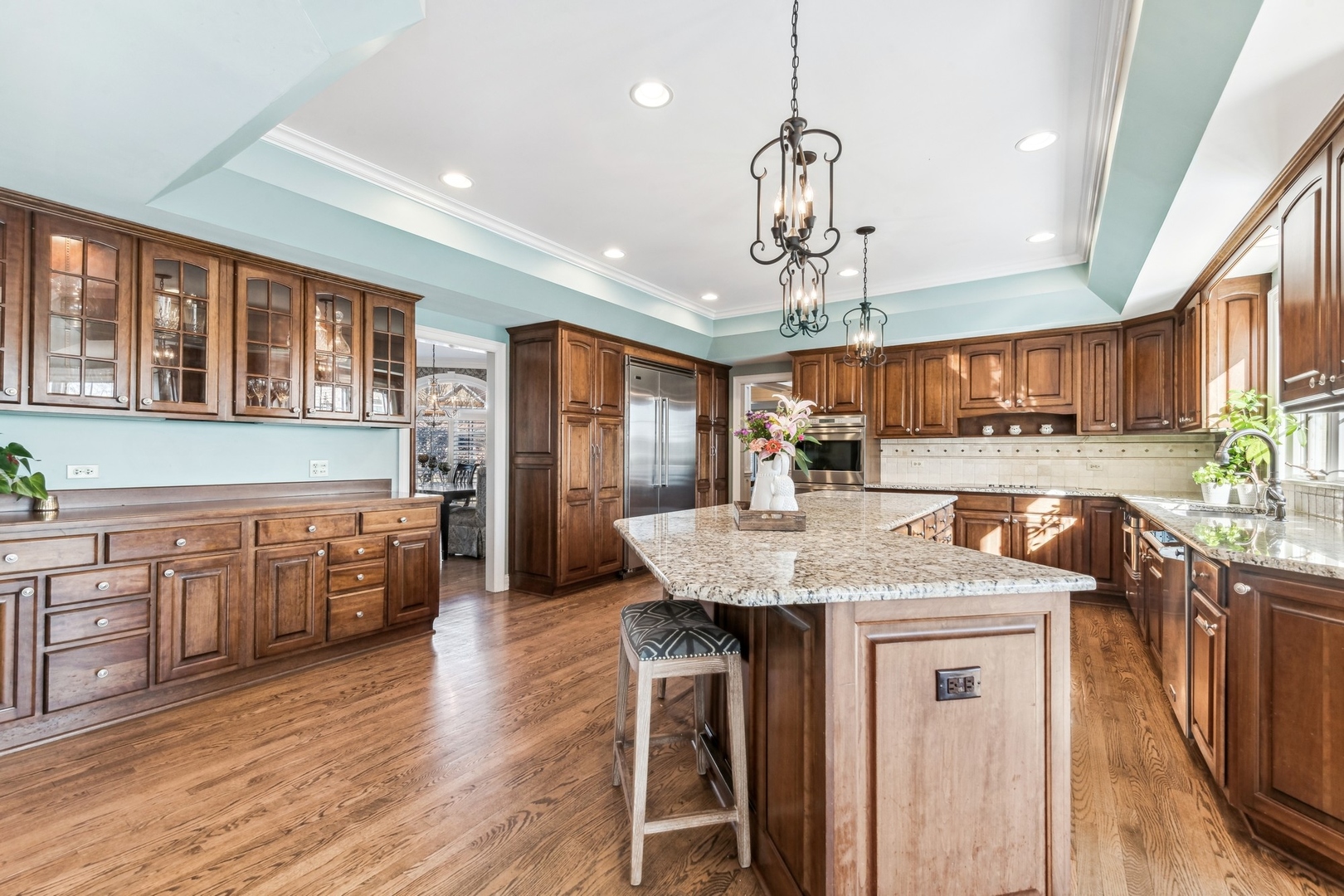 1334 Brandywine Road Libertyville, IL 60048 - Photo 9 of 32 a kitchen with stainless steel appliances granite countertop wooden floors and white cabinets