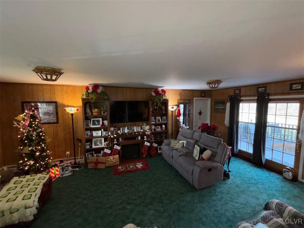 1494 Teels Road Pen Argyl, PA 18072 - Photo 4 of 12 a living room with furniture a flat screen tv and a large window