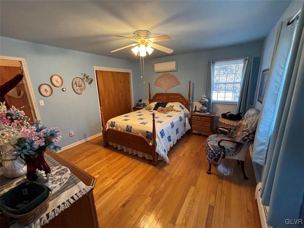 1494 Teels Road Pen Argyl, PA 18072 - Photo 8 of 12 a bedroom with a bed and a chandelier