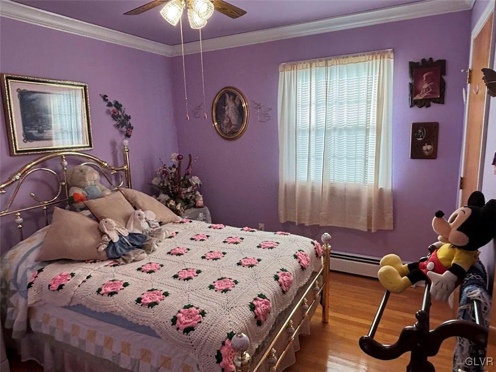 1494 Teels Road Pen Argyl, PA 18072 - Photo 10 of 12 a bedroom with a bed and a chandelier