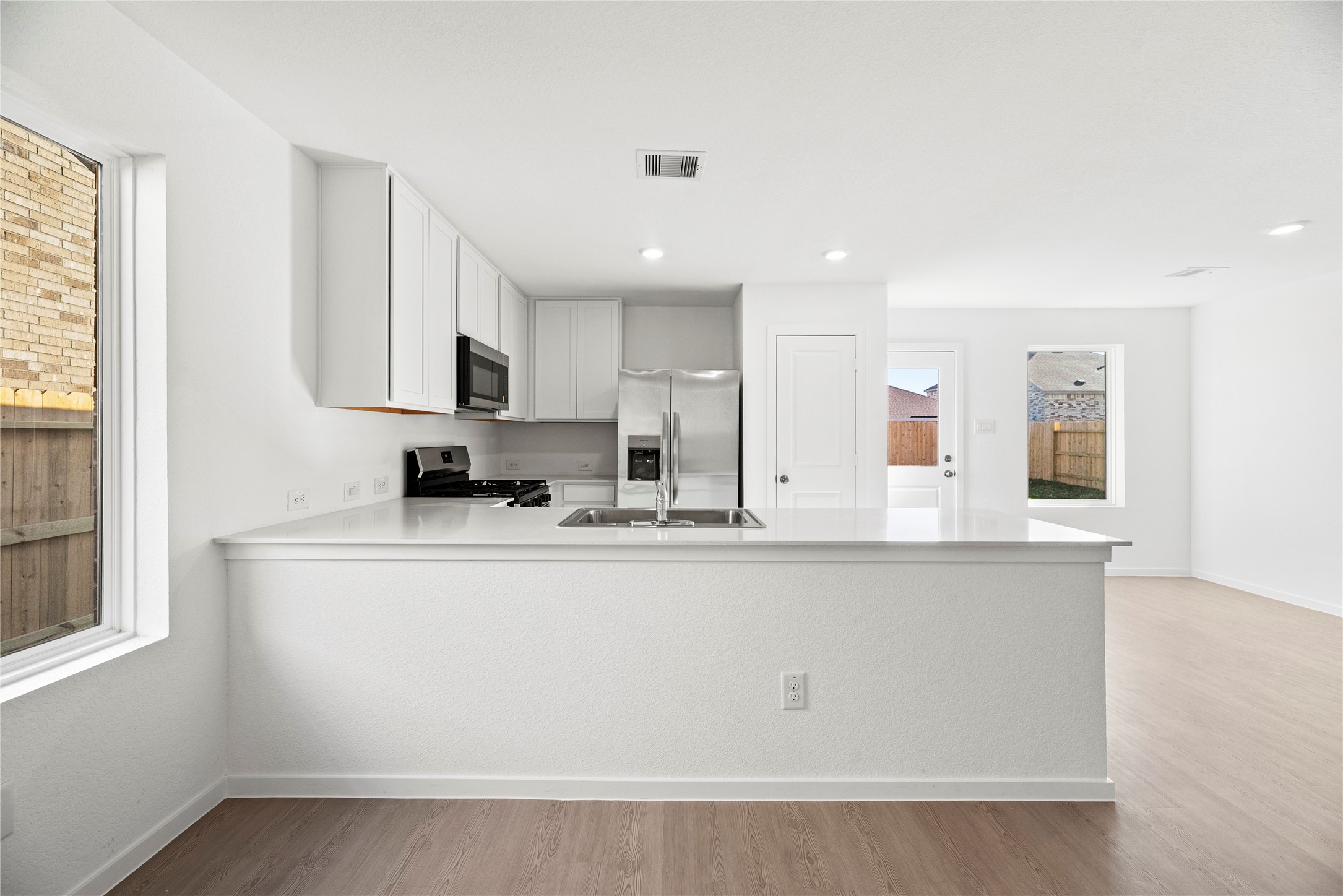 16222 Rustic Prairie Drive Hockley, TX 77447 - Photo 3 of 16 a view of kitchen with stainless steel appliances granite countertop refrigerator sink and stove