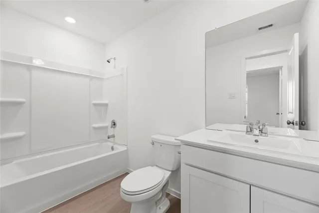 a bathroom with a sink toilet vanity and shower
