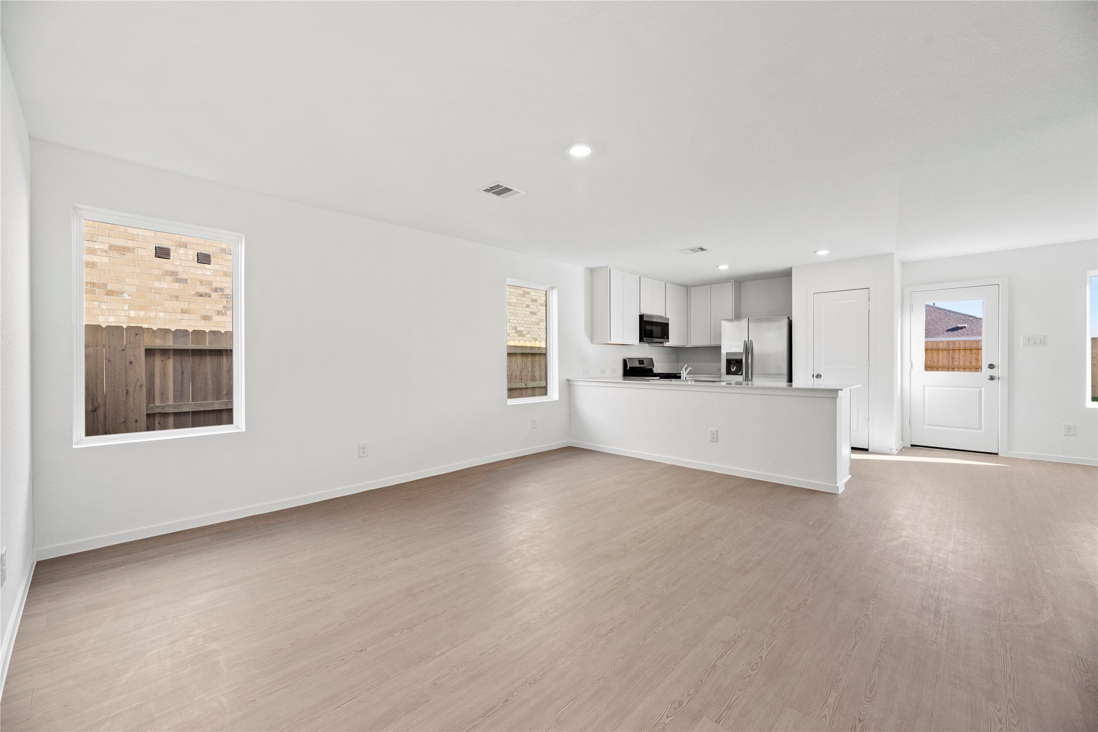 16222 Rustic Prairie Drive Hockley, TX 77447 - Photo 9 of 16 a view of a kitchen with a sink cabinets and a window