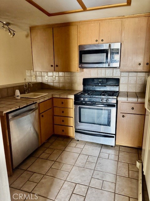 604 South Santa Fe Street, Unit 1 Hemet, CA 92543 - Photo 11 of 16 a kitchen with granite countertop a stove a sink and a microwave