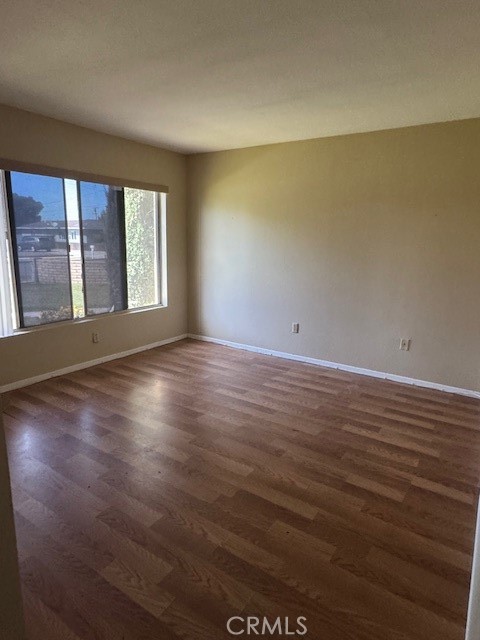 604 South Santa Fe Street, Unit 1 Hemet, CA 92543 - Photo 2 of 16 wooden floor in an empty room with a window