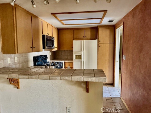 604 South Santa Fe Street, Unit 1 Hemet, CA 92543 - Photo 7 of 16 a kitchen with a refrigerator and a stove top oven