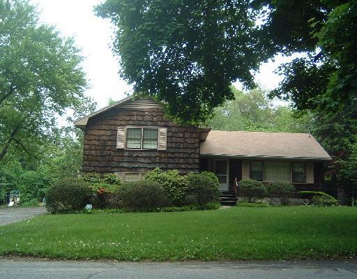 69 Random Road Fairfield, CT 06825 - Photo 1 of 1 a front view of a house with a garden