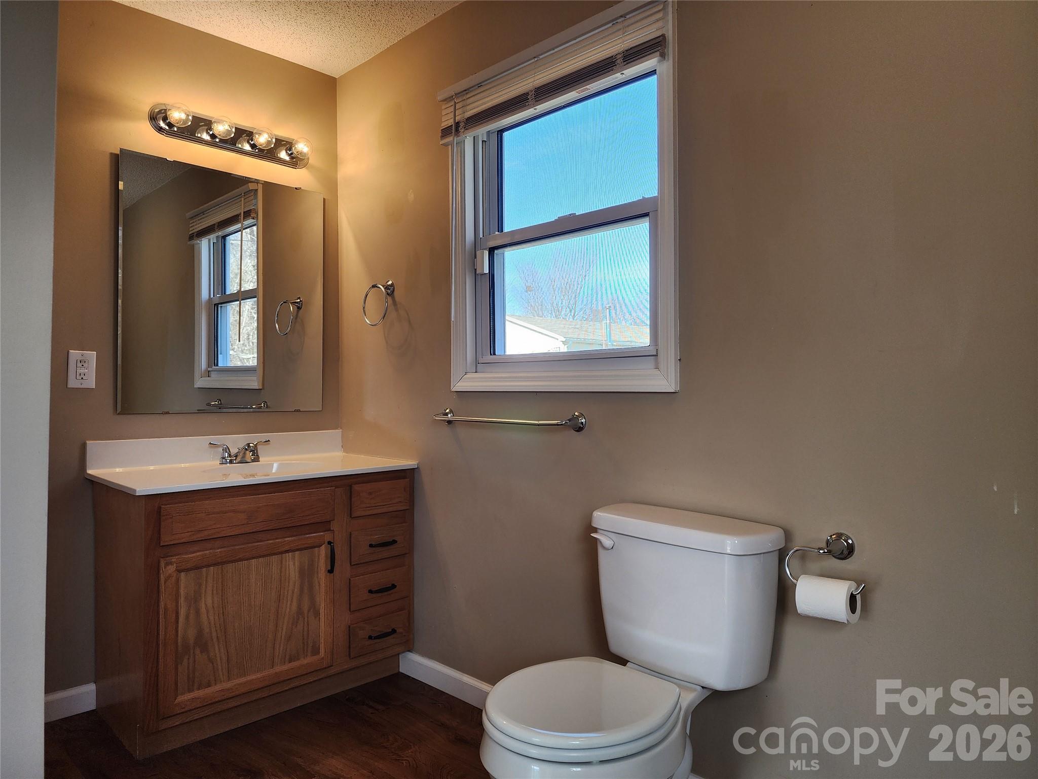 31 Stanley Street Candler, NC 28715 - Photo 12 of 22 a bathroom with a toilet sink and mirror