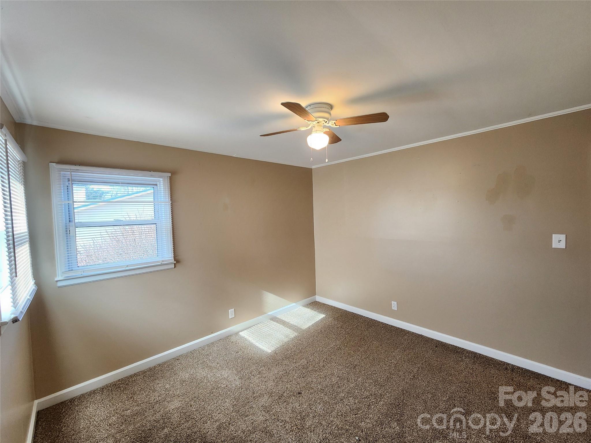 31 Stanley Street Candler, NC 28715 - Photo 14 of 22 an empty room with a window and a fan