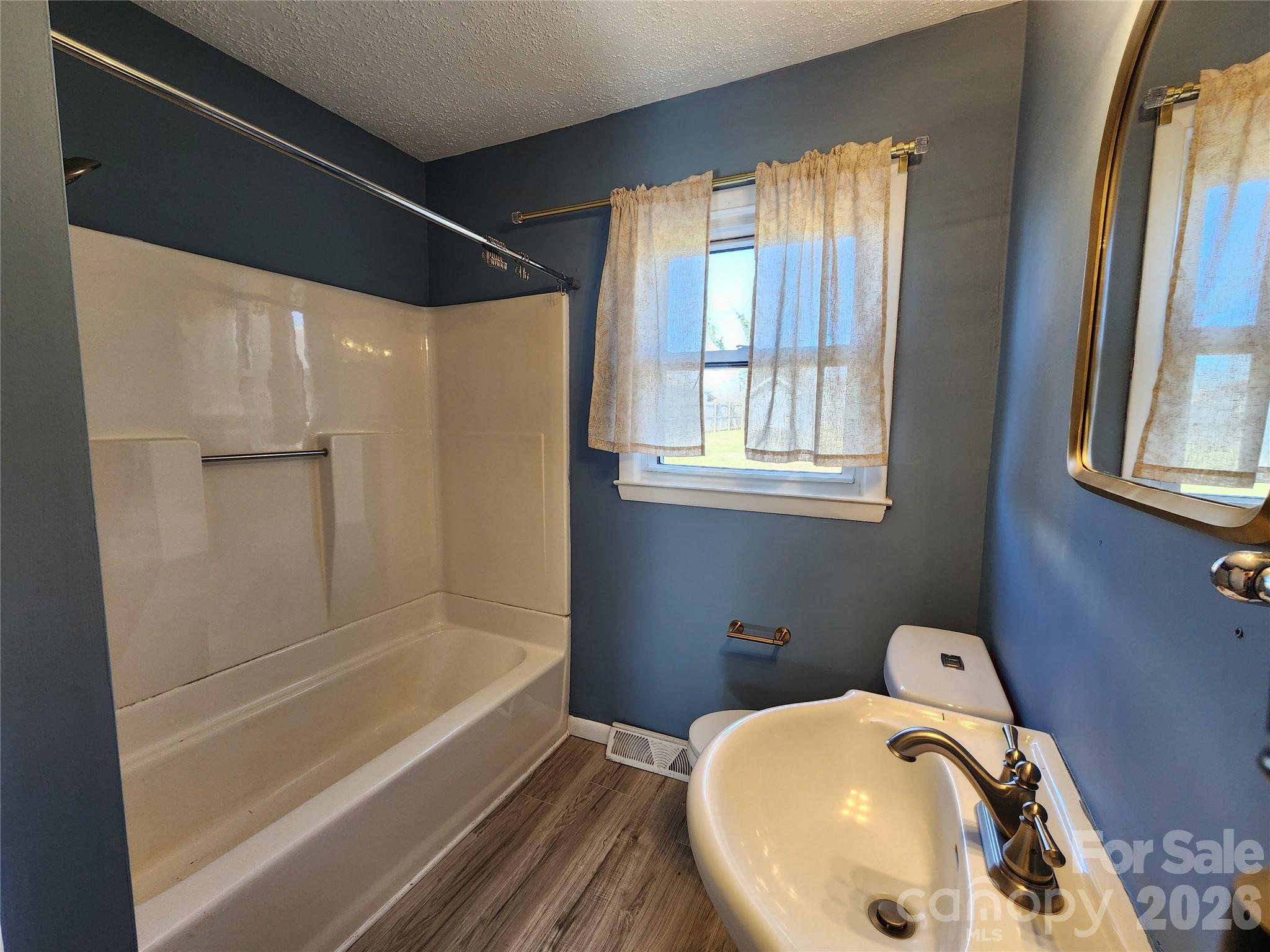 31 Stanley Street Candler, NC 28715 - Photo 17 of 22 a bathroom with a sink and a bathtub