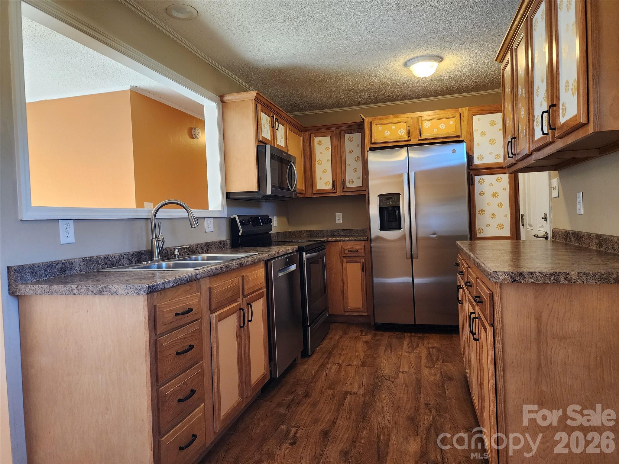 31 Stanley Street Candler, NC 28715 - Photo 7 of 22 a kitchen with stainless steel appliances granite countertop a stove a sink and a refrigerator