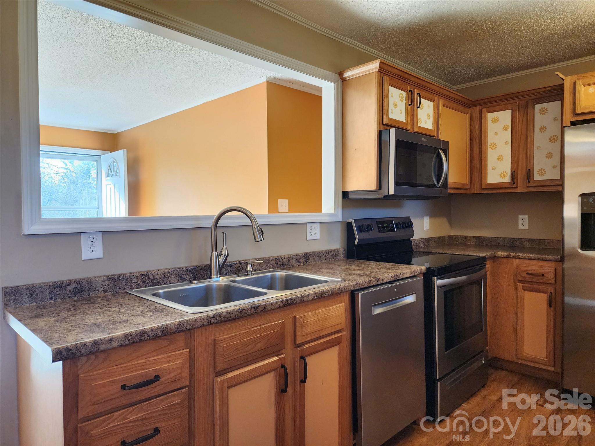 31 Stanley Street Candler, NC 28715 - Photo 8 of 22 a kitchen with stainless steel appliances granite countertop a sink stove and microwave