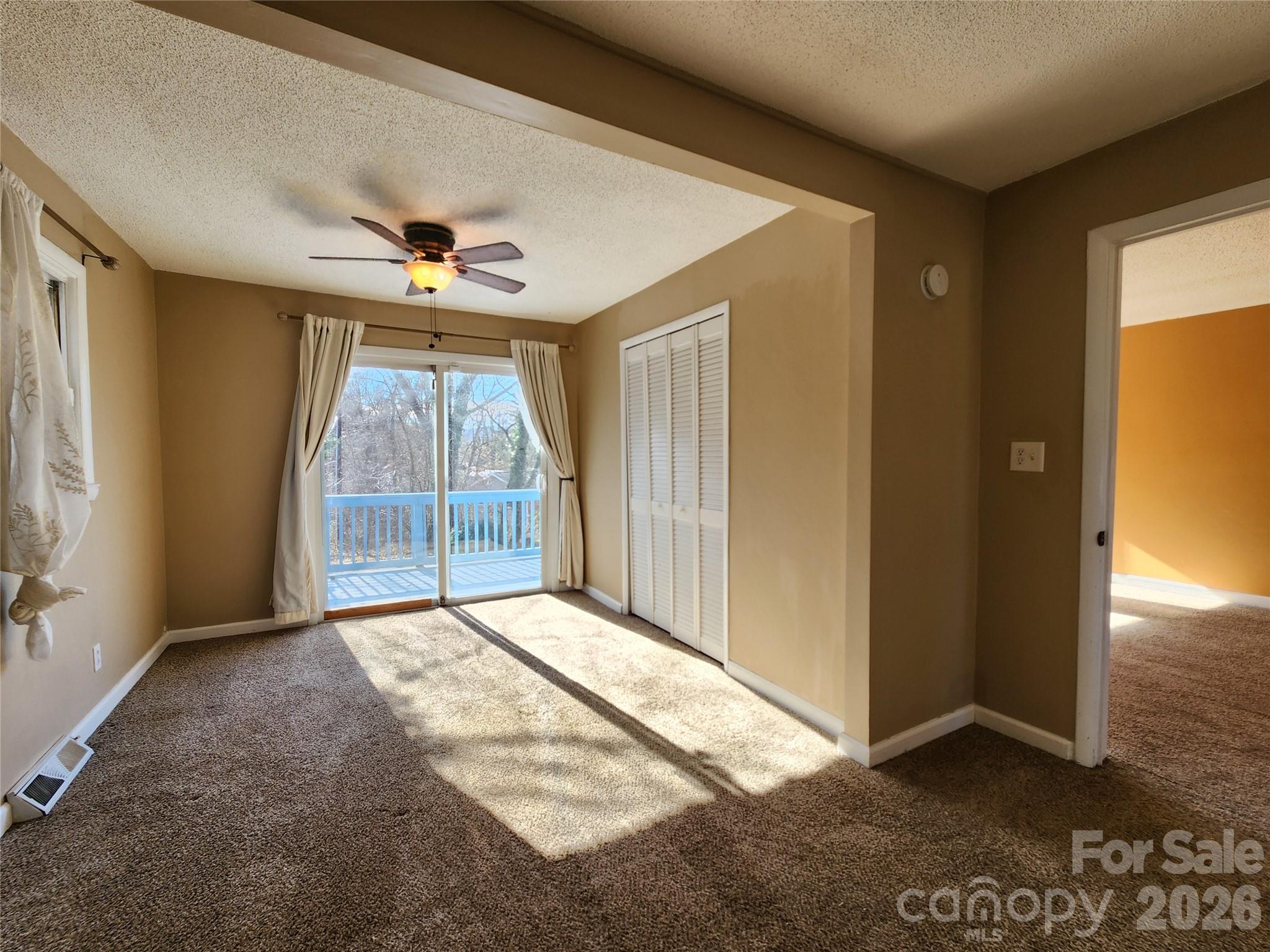 31 Stanley Street Candler, NC 28715 - Photo 10 of 22 an empty room with windows and chandelier