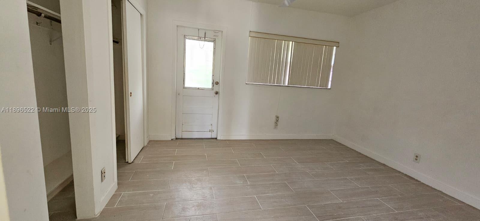 230 Southwest 11th Avenue, Unit 14 Hallandale Beach, FL 33009 - Photo 15 of 20 an empty room with windows