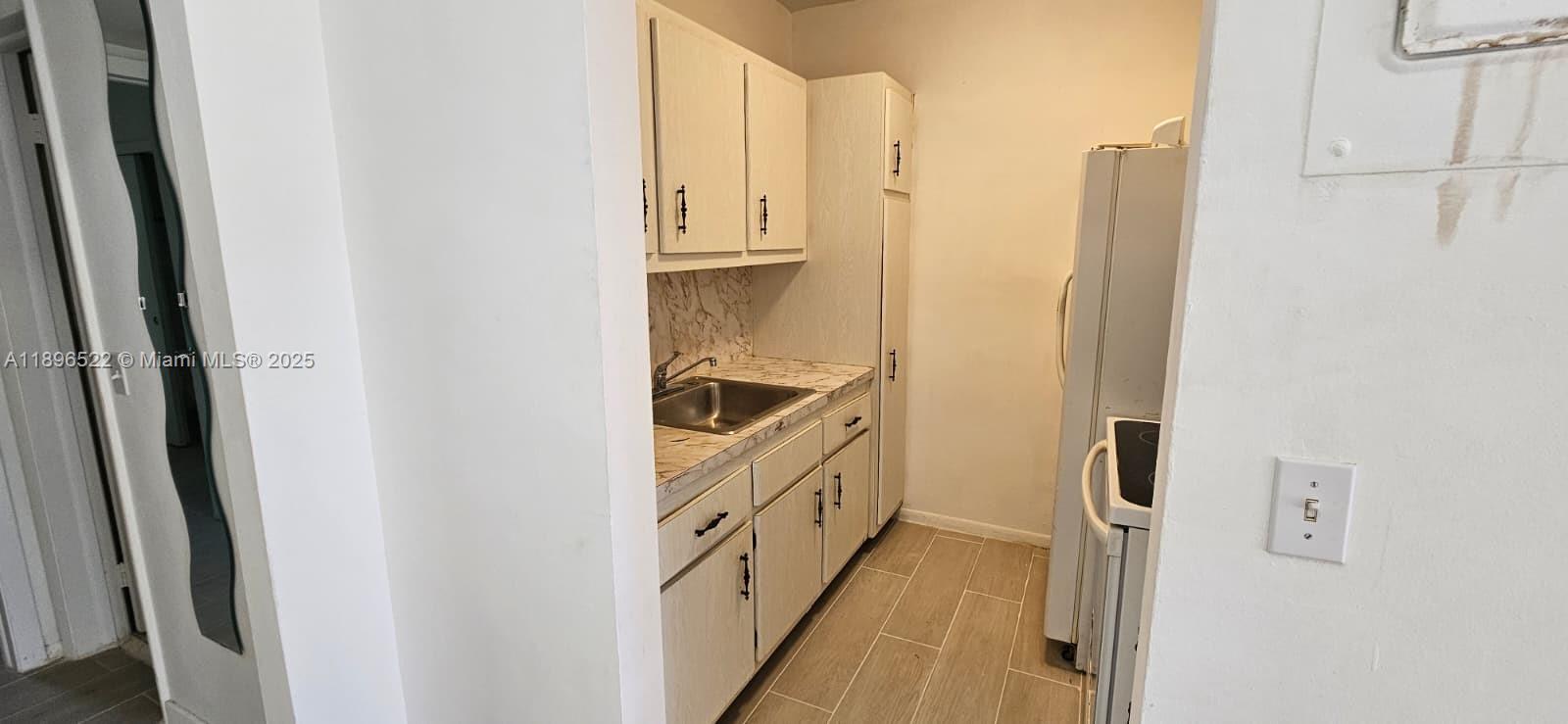230 Southwest 11th Avenue, Unit 14 Hallandale Beach, FL 33009 - Photo 16 of 20 a bathroom with a double vanity sink and a mirror