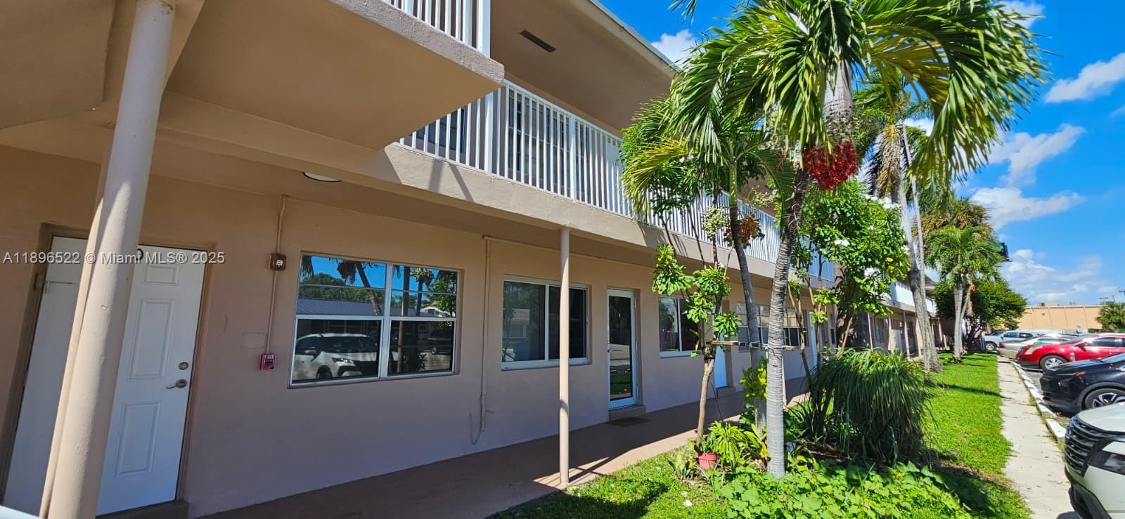 230 Southwest 11th Avenue, Unit 14 Hallandale Beach, FL 33009 - Photo 19 of 20 a view of a house with a flower garden