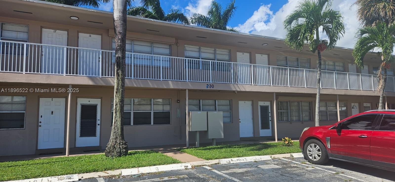 230 Southwest 11th Avenue, Unit 14 Hallandale Beach, FL 33009 - Photo 20 of 20 a front view of a house with a garden
