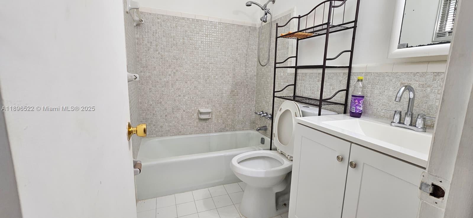 230 Southwest 11th Avenue, Unit 14 Hallandale Beach, FL 33009 - Photo 8 of 20 a bathroom with a sink a toilet and shower