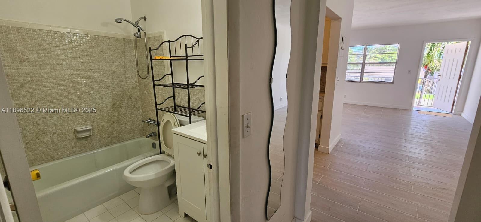 230 Southwest 11th Avenue, Unit 14 Hallandale Beach, FL 33009 - Photo 10 of 20 a bathroom with a shower and a toilet