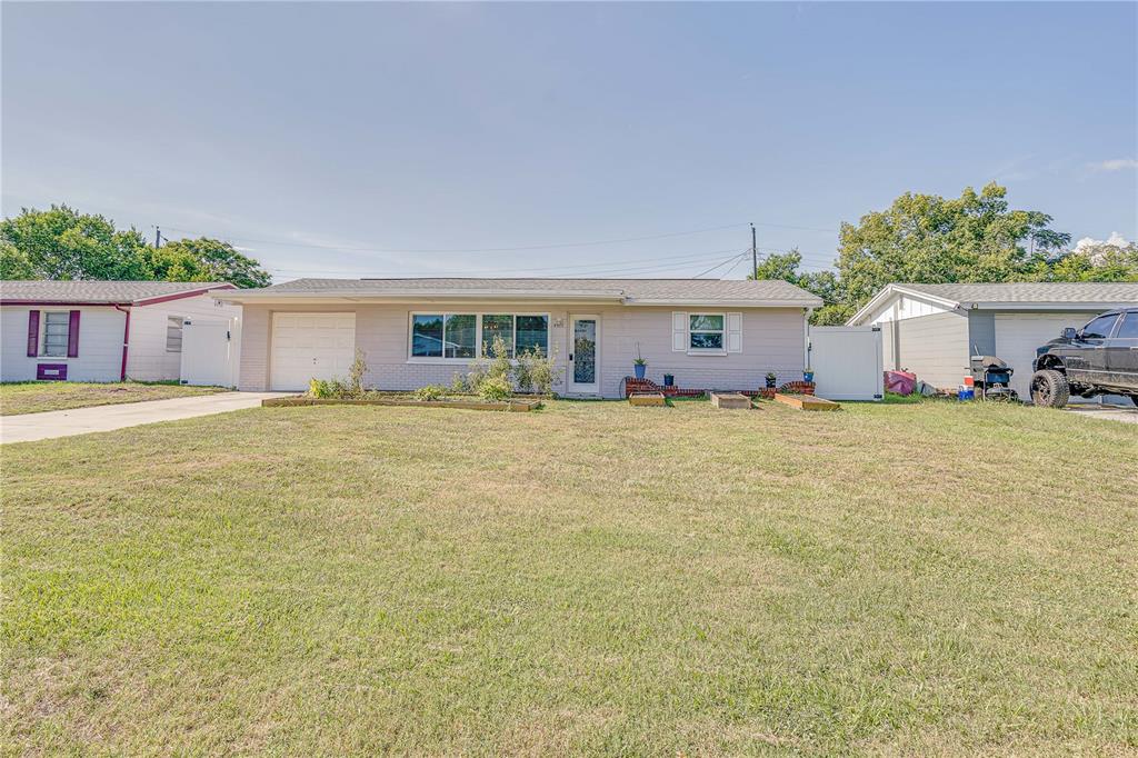 4917 Bartelt Road Holiday, FL 34690 - Photo 1 of 1 a front view of house with yard and trees around
