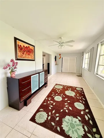 a spacious bedroom with a bed and a chandelier