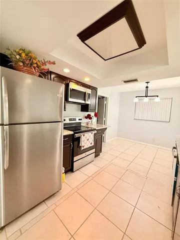 a kitchen with stainless steel appliances a refrigerator and a stove top oven