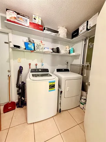 a utility room with sink dryer and washer