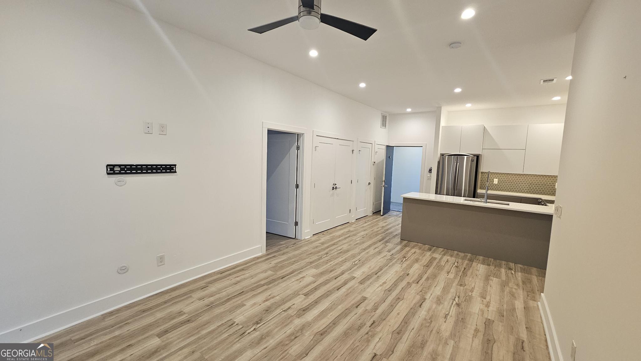 1155 Custer Avenue Southeast, Unit 101 Atlanta, GA 30316 - Photo 13 of 27 an empty room with wooden floor and windows